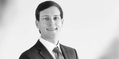 Black and white headshot of Dylan Futrell, a litigation attorney at Fishman Haygood